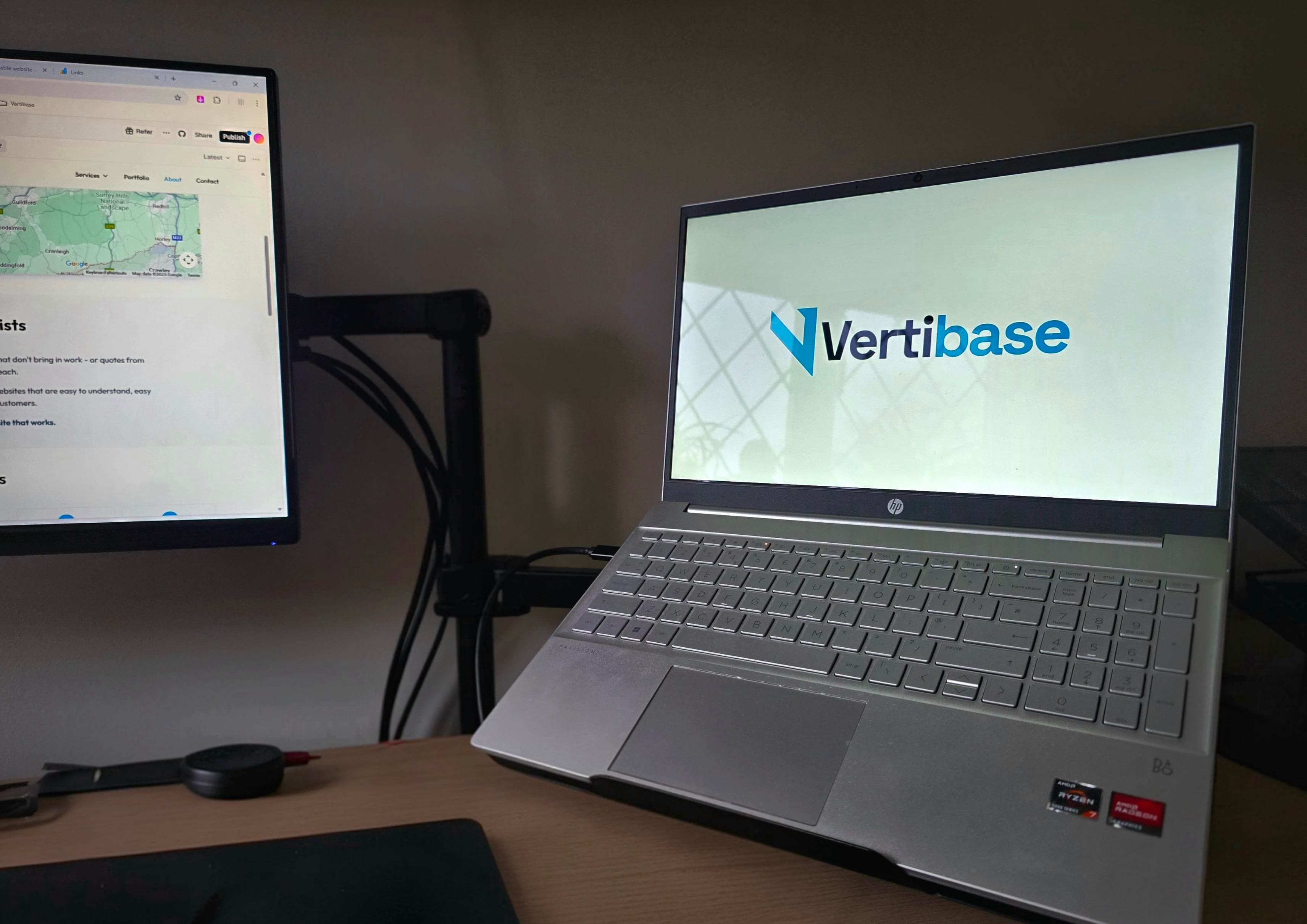 Vertibase workspace with laptop displaying logo