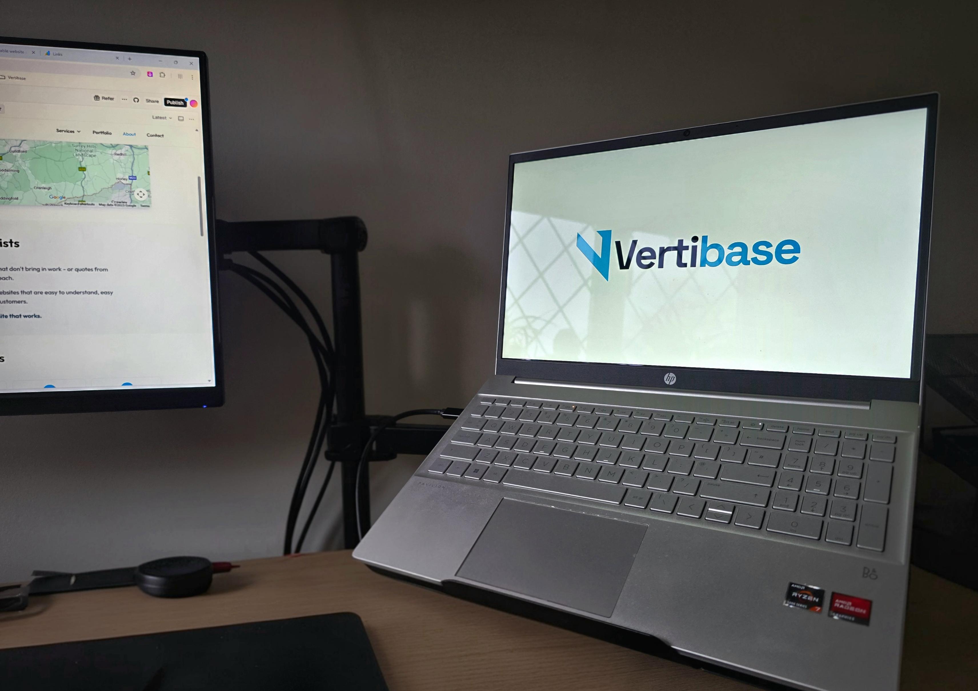 Vertibase workspace with laptop displaying logo